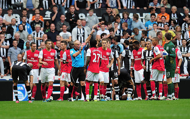 NEWCASTLE UPON TYNE, ENGLAND - AUGUST 13: Gervinho of Arsenal is shown the red card by referee Peter Walton during the Barclays Premier League match between Newcastle United and Arsenal at St James' Park on August 13, 2011 in Newcastle upon Tyne, England. (Photo by Shaun Botterill/Getty Images)