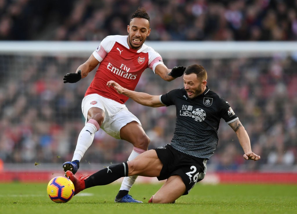 LONDON, ENGLAND - DECEMBER 22: Pierre-Emerick Aubameyang of Arsenal is tackled by Phillip Bardsley of Burnley during the Premier League match between Arsenal FC and Burnley FC at Emirates Stadium on December 22, 2018 in London, United Kingdom. (Photo by Shaun Botterill/Getty Images)
