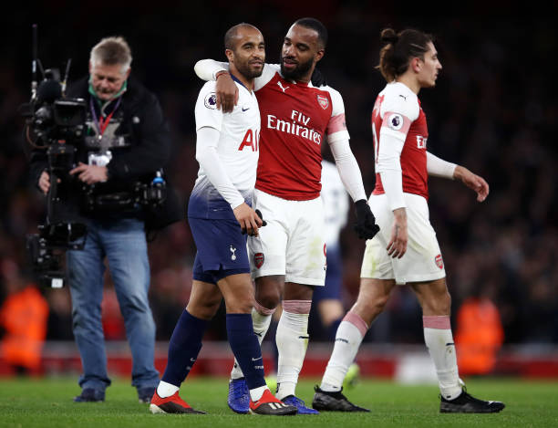 LONDON, ENGLAND - DECEMBER 02: Lucas Moura of Tottenham Hotspur and Alexandre Lacazette of Arsenal embrace after the match during the Premier League match between Arsenal FC and Tottenham Hotspur at Emirates Stadium on December 1, 2018 in London, United Kingdom. (Photo by Julian Finney/Getty Images)