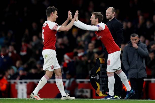 Arsenal's Spanish defender Nacho Monreal (R) taps hands with Arsenal's French defender Laurent Koscielny as he comes on to replace him during their UEFA Europa league Group E football match between Arsenal and FK Qarabag at the Emirates stadium in London on December 13, 2018. (Photo by Adrian DENNIS / AFP) 