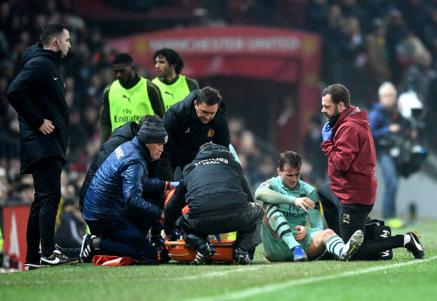 MANCHESTER, ENGLAND - DECEMBER 05: Rob Holding of Arsenal receives medical treatment during the Premier League match between Manchester United and Arsenal FC at Old Trafford on December 5, 2018 in Manchester, United Kingdom. (Photo by Michael Regan/Getty Images)