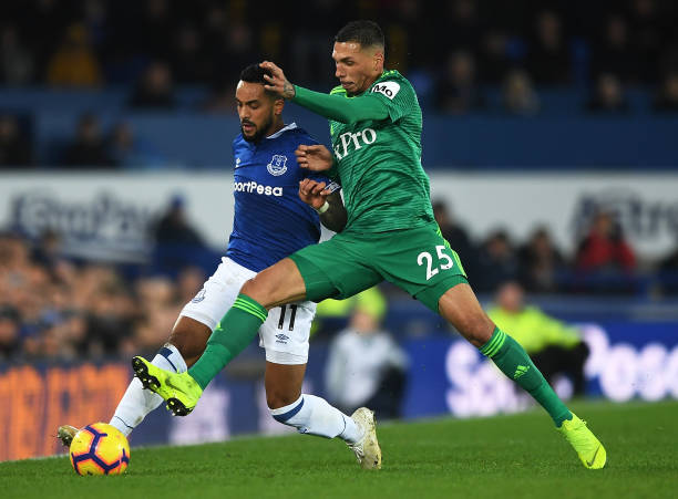 LIVERPOOL, ENGLAND - DECEMBER 10:  Theo Walcott of Everton battles with Jose Holebas of Watford during the Premier League match between Everton FC and Watford FC at Goodison Park on December 10, 2018 in Liverpool, United Kingdom.  (Photo by Gareth Copley/Getty Images)