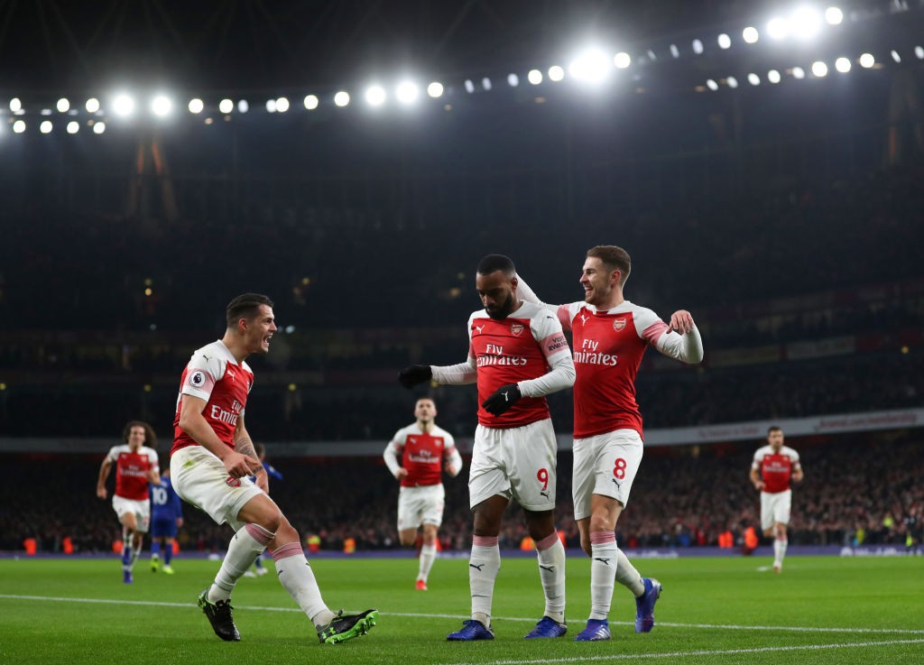 LONDON, ENGLAND - JANUARY 19: Alexandre Lacazette of Arsenal celebrates scoring his teams first goal with Granit Xhaka and Aaron Ramsey during the Premier League match between Arsenal FC and Chelsea FC at Emirates Stadium on January 19, 2019 in London, United Kingdom. (Photo by Catherine Ivill/Getty Images)