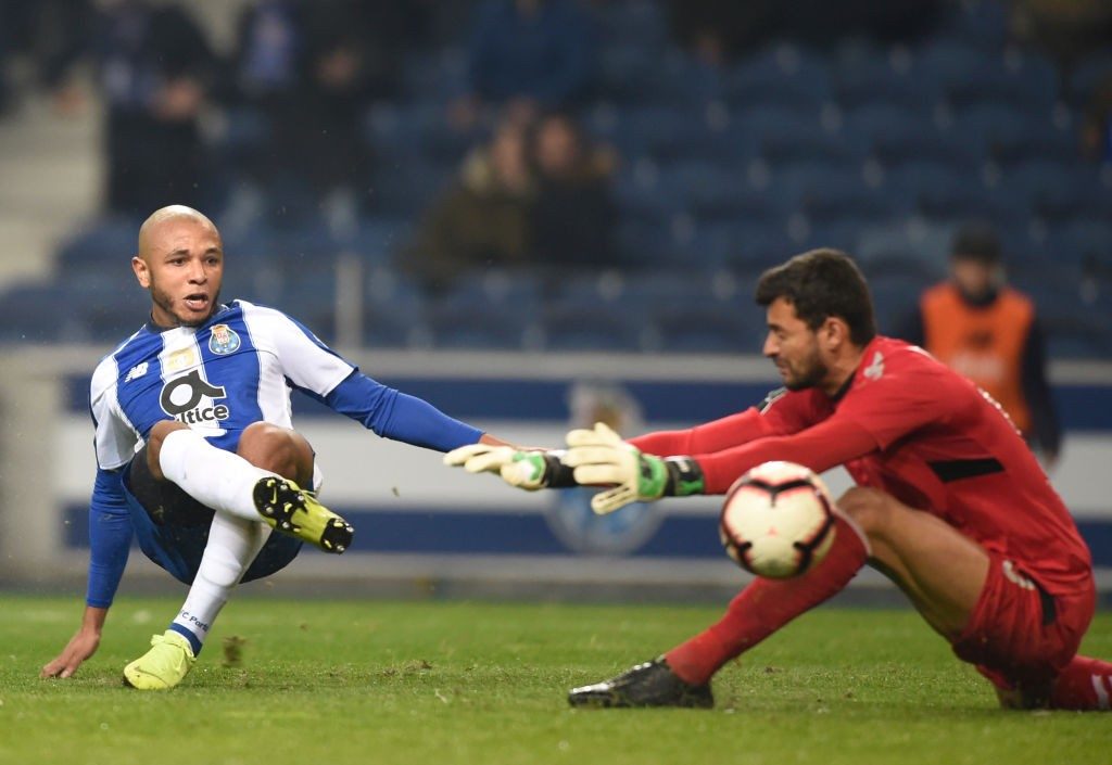 Porto's Algerian forward Yacine Brahimi (L) scores a goal to Nacional's Brazilian goalkeeper Daniel Guimaraes during the Portuguese League football match between FC Porto and CD Nacional Funchal at the Dragao stadium in Porto on January 7, 2019. (Photo by MIGUEL RIOPA / AFP / Getty Images)