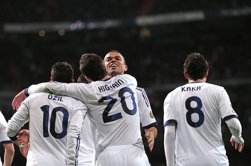 MADRID, SPAIN - MARCH 16: Gonzalo Higuain (#20) of Real Madrid CF celebrates with Mesut Ozil, Kaka and Pepe after scoring Real's 4th goal during the La Liga match between Real Madrid CF and RCD Mallorca at estadio Santiago Bernabeu on March 16, 2013 in Madrid, Spain. (Photo by Denis Doyle/Getty Images)