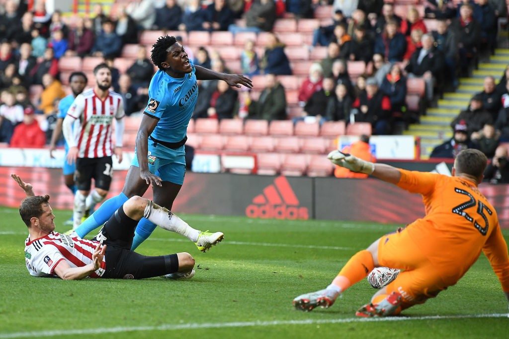 SHEFFIELD, ENGLAND - JANUARY 06: Shaquile Coulthirst of Barnet is fouled by Richard Stearman of Sheffield United leading to a penalty during the FA Cup Third Round match between Sheffield United and Barnet at Bramall Lane on January 06, 2019 in Sheffield, United Kingdom. (Photo by Michael Regan/Getty Images)