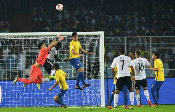 Gabriel Brazao (L) of Brazil makes a save the during the quarterfinal football match against Germany of the FIFA U-17 World Cup at the Vivekananda Yuba Bharati Krirangan stadium in Kolkata on October 22, 2017. The FIFA U-17 Football World Cup is taking place in India from October 6 to 28. / AFP PHOTO / Dibyangshu SARKAR