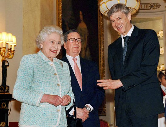 London, UNITED KINGDOM: Britain's Queen Elizabeth II meets with Arsenal chairman Peter Hill-Wood and manager Arsene Wenger (R) at Buckingham Palace, 15 February 2007. Queen Elizabeth II hosted Arsenal footballers in a teatime fixture at Buckingham Palace 15 February to make up for her having to forfeit opening their new ground last November because of a bad back. The 80-year-old monarch invited the English Premiership club's players and staff to the palace for a tour of the State Apartments before their gathering in the Bow Room. AFP PHOTO / PA / Fiona Hanson