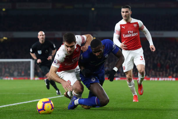 LONDON, ENGLAND - JANUARY 19:  Antonio Ruediger of Chelsea battles for possession with Sokratis Papastathopoulos of Arsenal during the Premier League match between Arsenal FC and Chelsea FC at Emirates Stadium on January 19, 2019 in London, United Kingdom.  (Photo by Clive Rose/Getty Images)