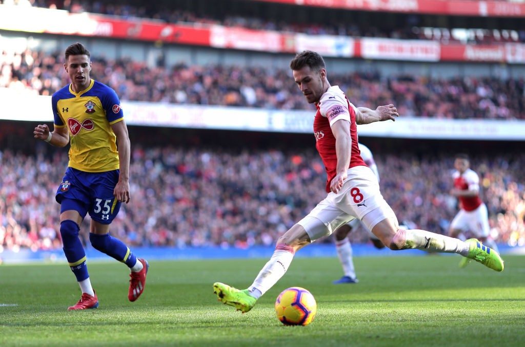 LONDON, ENGLAND - FEBRUARY 24: Aaron Ramsey of Arsenal crosses the ball past Jan Bednarek of Southampton during the Premier League match between Arsenal FC and Southampton FC at Emirates Stadium on February 23, 2019 in London, United Kingdom. (Photo by Richard Heathcote/Getty Images)