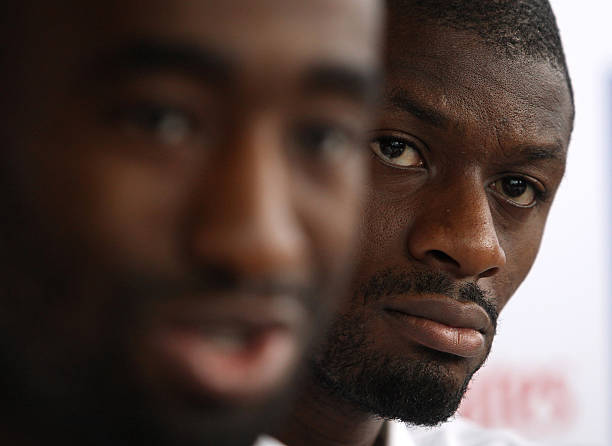 Abou Diaby (R), player of English premier league football team Arsenal, attends a press conference in Hong Kong on July 28, 2012. Arsenal will play Hong Kong side Kitchee on July 29. AFP PHOTO / Dale de la Rey 