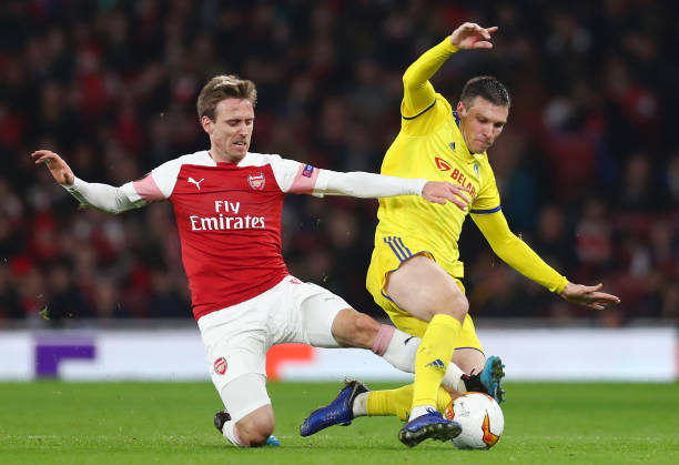 LONDON, ENGLAND - FEBRUARY 21: Nemanja Milic of FC BATE is challenged by Nacho Monreal of Arsenal during the UEFA Europa League Round of 32 Second Leg match between Arsenal and BATE Borisov at Emirates Stadium on February 21, 2019 in London, United Kingdom. (Photo by Clive Rose/Getty Images)