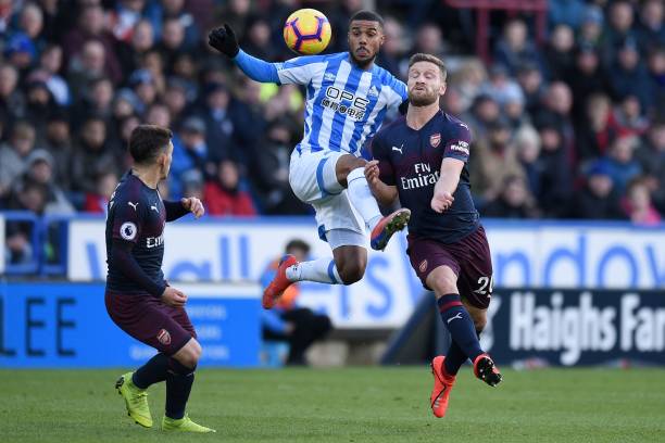 Huddersfield Town's Swiss-born Dutch defender Terence Kongolo (C) vies with Arsenal's Uruguayan midfielder Lucas Torreira (L) and Arsenal's German defender Shkodran Mustafi during the English Premier League football match between Huddersfield Town and Arsenal at the John Smith's stadium in Huddersfield, northern England on February 9, 2019. (Photo by Oli SCARFF / AFP) 