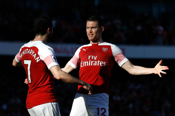 Arsenal's Armenian midfielder Henrikh Mkhitaryan (L) celebrates with Arsenal's Swiss defender Stephan Lichtsteiner after scoring their second goal during the English Premier League football match between Arsenal and Southampton at the Emirates Stadium in London on February 24, 2019. (Photo by Ian KINGTON / AFP)