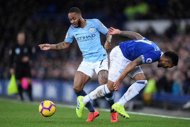 LIVERPOOL, ENGLAND - FEBRUARY 06: Raheem Sterling of Manchester City takes on Theo Walcott of Everton during the Premier League match between Everton FC and Manchester City at Goodison Park on February 06, 2019 in Liverpool, United Kingdom. (Photo by Laurence Griffiths/Getty Images)