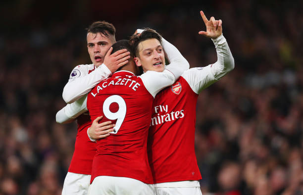 LONDON, ENGLAND - DECEMBER 22: Mesut Ozil of Arsenal (R) celebrates as he scores their third goal with Granit Xhaka and Alexandre Lacazette during the Premier League match between Arsenal and Liverpool at Emirates Stadium on December 22, 2017 in London, England. (Photo by Catherine Ivill/Getty Images)