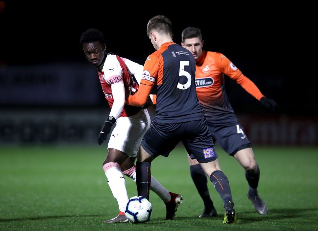 BOREHAMWOOD, ENGLAND - MARCH 04: Folarin Balogun of Arsenal is tackled by Keston Davies of Swansea during the Premier League 2 match between Arsenal and Swansea at Meadow Park on March 04, 2019 in Borehamwood, England. (Photo by Alex Pantling/Getty Images)