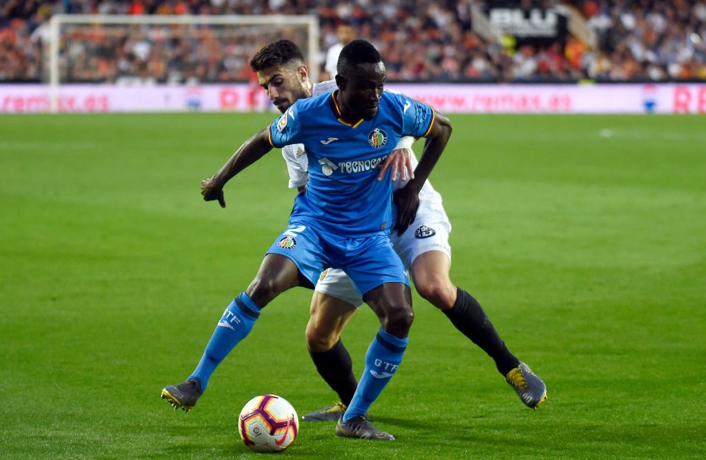 Getafe's Togolese defender Djene Ortega (L) vies with Valencia's Italian defender Cristiano Piccini during the Spanish league football match between Valencia CF and Getafe CF at the Mestalla stadium in Valencia on March 17, 2019. (Photo by JOSE JORDAN / AFP / Getty Images)