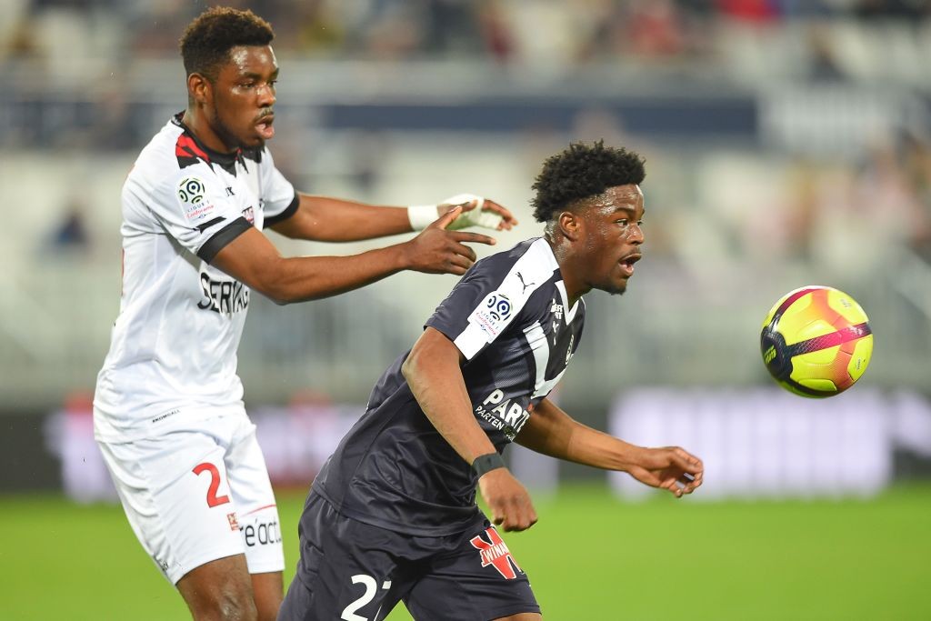 Bordeaux's English forward Josh Maja (R) vies with Guingamp's Cameroonian defender Felix Eboa Eboa during the French L1 football match between Girondins de Bordeaux (FCGB) and En avant de Guingamp (EAG) on February 20, 2019 at the Matmut Atlantique stadium in Bordeaux, southwestern France. (Photo by NICOLAS TUCAT / AFP / Getty Images)
