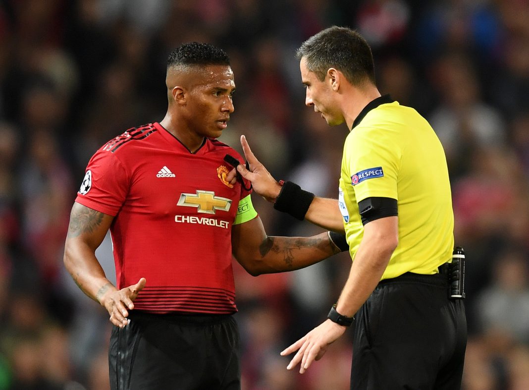 MANCHESTER, ENGLAND - OCTOBER 02: Referee Slavko Vincic speaks to Antonio Valencia of Manchester United during the Group H match of the UEFA Champions League between Manchester United and Valencia at Old Trafford on October 2, 2018, in Manchester, United Kingdom. (Photo by Michael Regan/Getty Images)