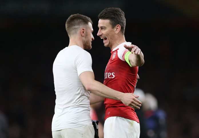 LONDON, ENGLAND - MARCH 14: Laurent Koscielny of Arsenal celebrates victory with teammate Aaron Ramsey after the UEFA Europa League Round of 16 Second Leg match between Arsenal and Stade Rennais at Emirates Stadium on March 14, 2019, in London, England. (Photo by Alex Morton/Getty Images)