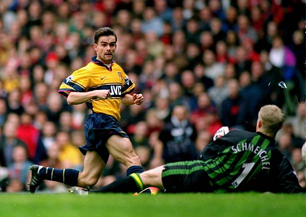 14 Mar 1998: Marc Overmars of Arsenal scores the winner against Manchester United during the FA Carling Premiership match at Old Trafford in Manchester, England. Arsenal won 1-0. Mandatory Credit: Shaun Botterill /Allsport