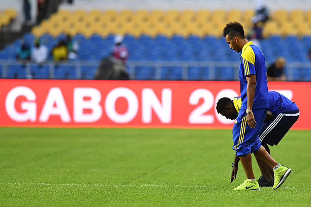 Gabon's forward Pierre-Emerick Aubameyang and Gabon's defender Bruno Ecuele Manga (back) check the pitch ahead of the 2017 Africa Cup of Nations group A football match between Cameroon and Gabon at the Stade de l'Amitie Sino-Gabonaise in Libreville on January 22, 2017. / AFP / GABRIEL BOUYS 