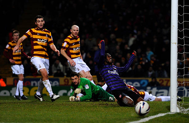 BRADFORD, ENGLAND - DECEMBER 11: Gervinho of Arsenal reacts after missing a chance on goal during the Capital One Cup quarter final match between Bradford City and Arsenal at the Coral Windows Stadium, Valley Parade on December 11, 2012 in Bradford, England. (Photo by Laurence Griffiths/Getty Images)