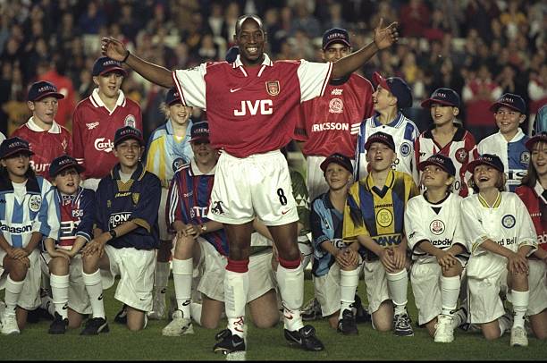 24 Sep 1997: Ian Wright of Arsenal celebrates with some young fans after beating Cliff Baston of Arsenal's goal scoring record during an FA Carling Premiership match against West Ham United at the Highbury Stadium in London. Arsenal won the match 4-0. Credit: Michael Cooper/Allsport