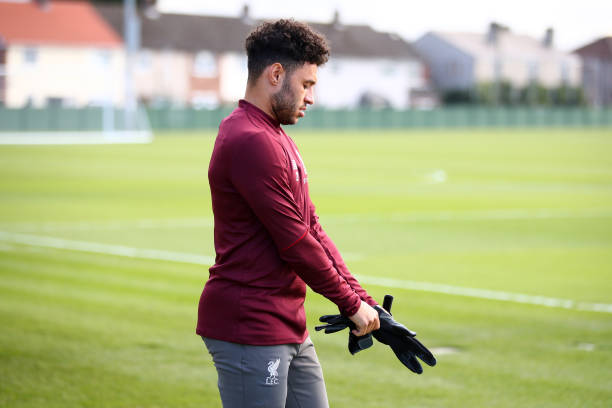 LIVERPOOL, ENGLAND - FEBRUARY 18: Alex Oxlade-Chamberlain of Liverpool puts on his gloves ahead of a Liverpool Training Session at Melwood Training Ground on February 18, 2019 in Liverpool, England. (Photo by Clive Brunskill/Getty Images)