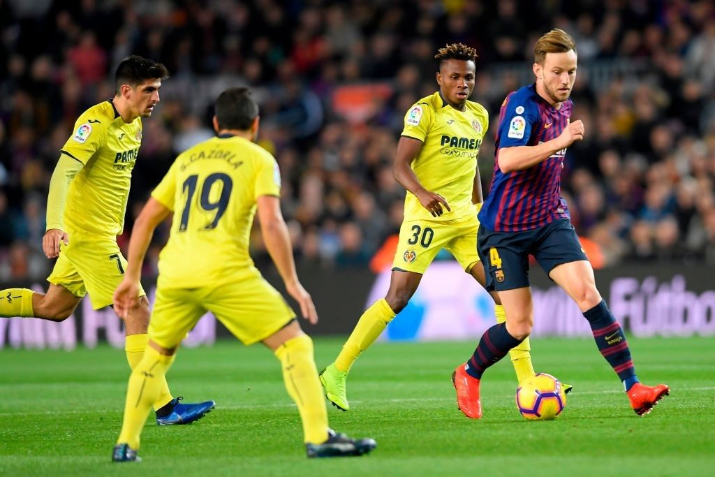 Barcelona's Croatian midfielder Ivan Rakitic (R) vies for the ball with Villarreal's Spanish forward Gerard Moreno, Villarreal's Spanish midfielder Santi Cazorla and Villarreal's Nigerian midfielder Samuel Chimerenka Chukwueze during the Spanish league football match FC Barcelona against Villarreal CF at the Camp Nou stadium in Barcelona on December 2, 2018. (Photo by LLUIS GENE / AFP / Getty Images)
