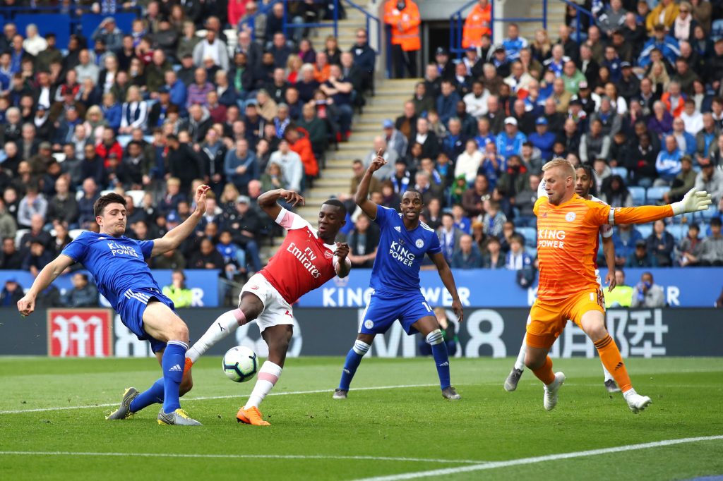 LEICESTER, ENGLAND - APRIL 28:  Eddie Nketiah of Arsenal is foiled by Harry Maguire and Kasper Schmeichel of Leicester City during the Premier League match between Leicester City and Arsenal FC at The King Power Stadium on April 28, 2019 in Leicester, United Kingdom. (Photo by Julian Finney/Getty Images)