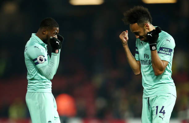WATFORD, ENGLAND - APRIL 15:  Pierre-Emerick Aubameyang of Arsenal (r) celebrates with Ainsley Maitland-Niles of Arsenal at the final whistle during the Premier League match between Watford FC and Arsenal FC at Vicarage Road on April 15, 2019 in Watford, United Kingdom. (Photo by Marc Atkins/Getty Images)