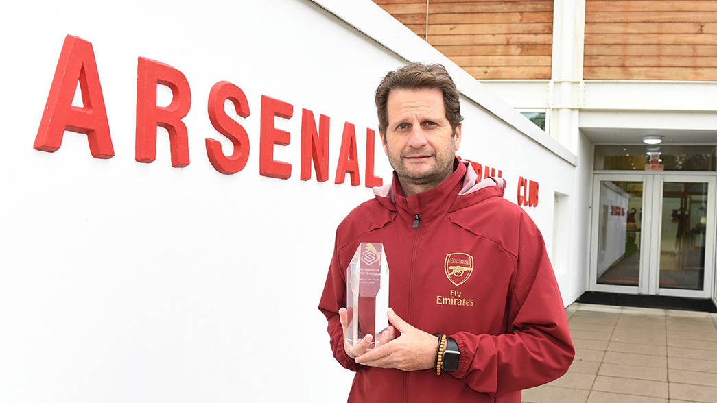 Joe Montemurro holds his crystal trophy via Arsenal.com