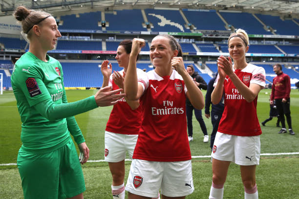 BRIGHTON, ENGLAND - APRIL 28: Sari van Veenendaal (L) and Katie McCabe of Arsenal Women celebrate winning the FA WSL League with the Arsenal supporters after the WSL match between Brighton and Hove Albion Women and Arsenal Women at Amex Stadium on April 28, 2019 in Brighton, England. (Photo by Steve Bardens/Getty Images)