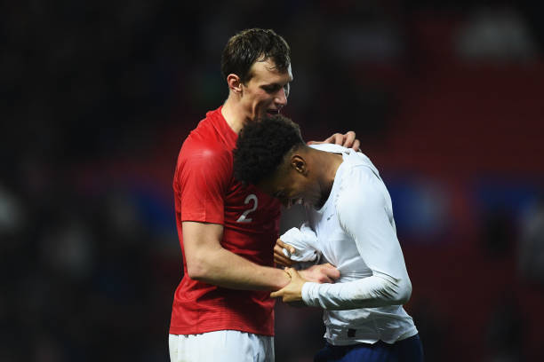 BRISTOL, ENGLAND - MARCH 21: Krystian Bielik of Poland and Reiss Nelson of England share a joke after the U21 International Friendly match between England and Poland at Ashton Gate on March 21, 2019 in Bristol, England. (Photo by Harry Trump/Getty Images)