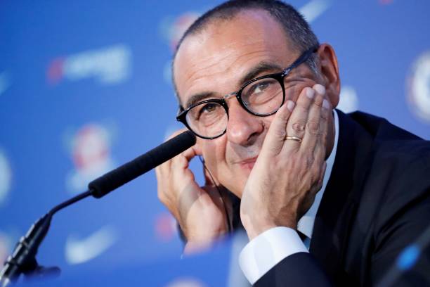 Chelsea's newly appointed manager, Maurizio Sarri, reacts during his unveiling press conference at Stamford Bridge in west London on July 18, 2018. - New Chelsea boss Maurizio Sarri has spoken of his excitement at facing many of the world's leading managers now that he in charge of a Premier League side. The Italian's arrival at Stamford Bridge, where he replaces compatriot Antonio Conte, sees him join a multi-national cast of managers in English football's top-flight, with Spain's Pep Guardiola in charge of champions Manchester City, Argentina's Mauricio Pochettino the manager of Tottenham Hotspur,  Portugal's Jose Mourinho at the helm of Manchester United and Germany's Jurgen Klopp in control at Liverpool. (Photo by Tolga AKMEN / AFP)    