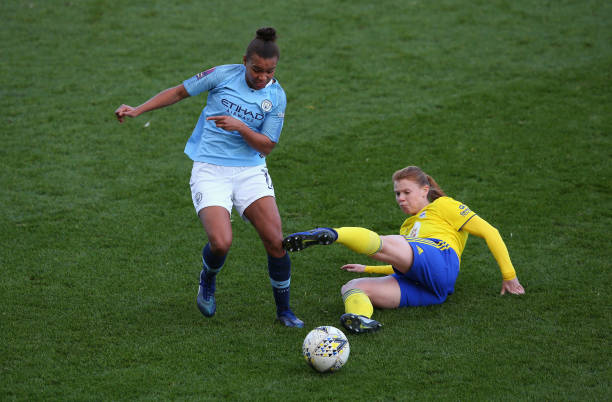 MANCHESTER, ENGLAND - DECEMBER 09: Nikita Parris of Manchester City Women is tackled by Meaghan Sargeant of Birmingham City Women during the FA WSL match between Manchester City Women and Birmingham City Women at The Academy Stadium on December 9, 2018 in Manchester, England. (Photo by Alex Livesey/Getty Images)