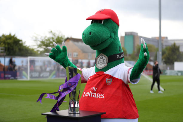 BOREHAMWOOD, ENGLAND - MAY 11: Gunnersaurus the Arsenal mascot with the Women's Super League trophy ahead of the WSL match between Arsenal Women and Manchester City at Meadow Park on May 11, 2019 in Borehamwood, England. (Photo by Catherine Ivill/Getty Images)
