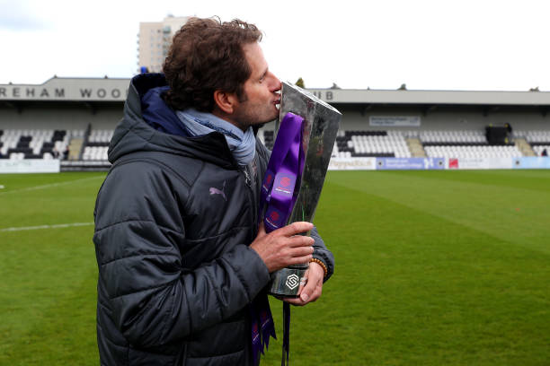 BOREHAMWOOD, ENGLAND - MAY 11: Joe Montemurro manager of Arsenal poses with the Women's Super League trophy after the WSL match between Arsenal Women and Manchester City Women at Meadow Park on May 11, 2019 in Borehamwood, England. (Photo by Catherine Ivill/Getty Images)