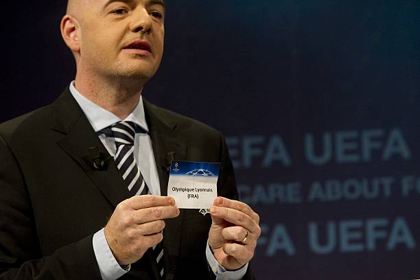 General secretary of the UEFA Gianni Infantino shows Olympique Lyonnais's name during the draw for the last 16 of the UEFA Champions League on December 16, 2011 at the UEFA headquarters in Nyon. England's two surviving representatives in the Champions League, Chelsea and Arsenal, were handed tough ties against Italian opposition in today's draw, while holders Barcelona will come up against Germany's Bayer Leverkusen. AFP PHOTO / SEBASTIEN BOZON