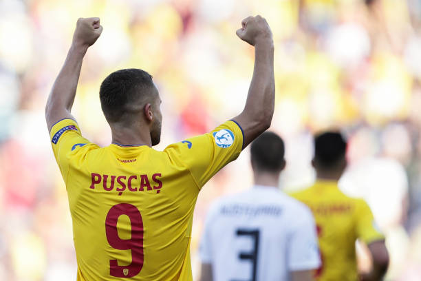 Romania's forward George Puscas celebrates after he scored a penalty during the semi-final match of the U21 European Football Championships between Germany and Romania on June 27, 2019 at the Renato Dall'Ara stadium in Bologna. (Photo by Isabella BONOTTO / Update Images Press / AFP) 