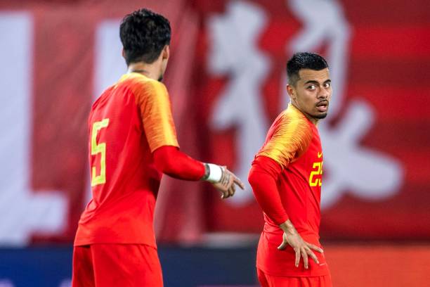 China's Nico Yennaris (R), known as Li Ke in Chinese, chats with teammate Zhang Linpeng during the team's football friendly against the Philippines in Guangzhou, in China's southern Guangdong province on June 7, 2019. (Photo by STR / AFP) 