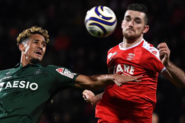 Saint-Etienne's French defender William Saliba (L) vies with Nîmes' French forward Clement Depres during the French League Cup round of 16 football match between Nimes Olympique and AS Saint-Etienne at the Costières stadium in Nîmes, southern France on November 27, 2018. (Photo by PASCAL GUYOT / AFP)