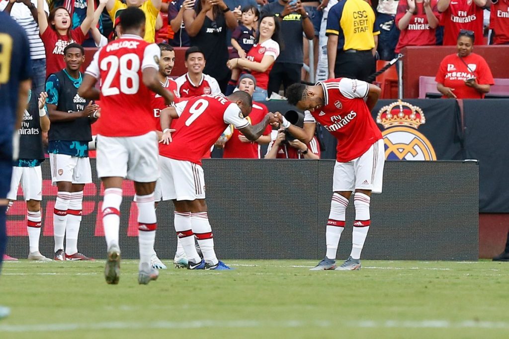 Alexandre Lacazette and Pierre-Emerick Aubameyang shake hands after Arsenal's second goal against Real Madrid in pre-season (Photo via AFP)