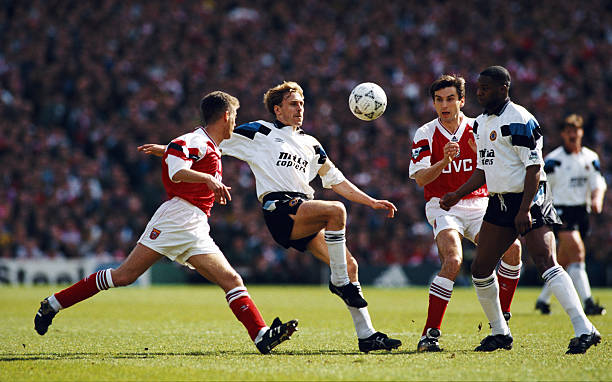 LONDON, UNITED KINGDOM - APRIL 12: Kevin Richardson of Aston Villa in action watched by Ian Sellley (l) Alan Smith (2nd r) and Dalian Atkinson (r) during a Premier League match between Arsenal and Aston Villa at Highbury on April 12, 1993 in London, England. (Photo by Shaun Botterill/Allsport/Getty Images)