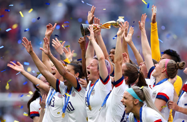 LYON, FRANCE - JULY 07: Megan Rapinoe of the USA lifts the FIFA Women's World Cup Trophy following her team's victory in the 2019 FIFA Women's World Cup France Final match between The United States of America and The Netherlands at Stade de Lyon on July 07, 2019 in Lyon, France. (Photo by Alex Grimm/Getty Images)