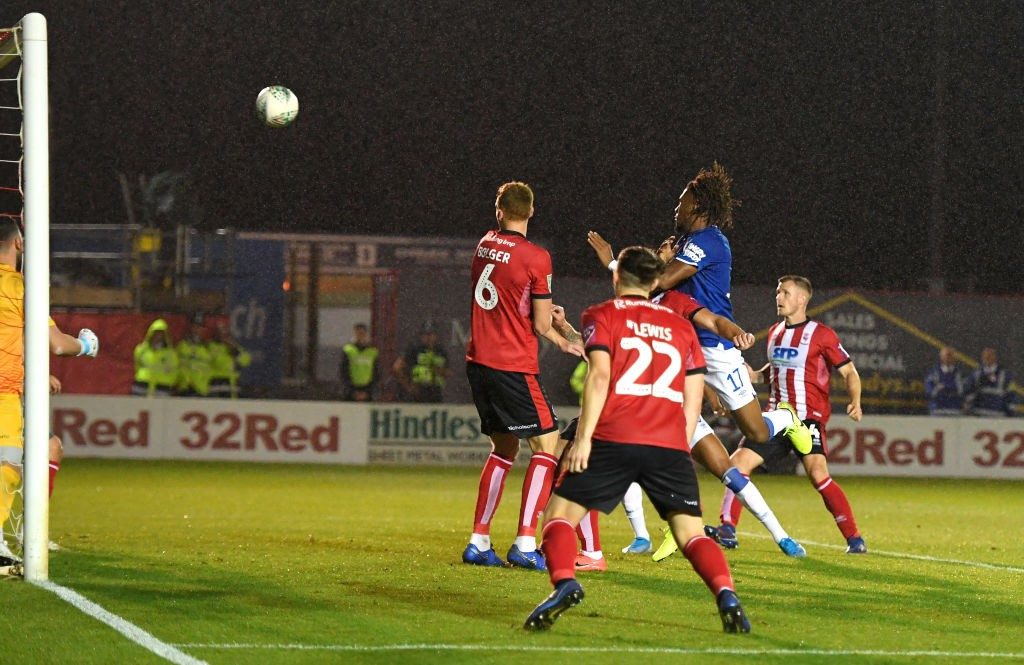 LINCOLN, ENGLAND - AUGUST 28: Alex Iwobi of Everton scores his team's third goal during the Carabao Cup Second Round match between Lincoln City and Everton at Sincil Bank Stadium on August 28, 2019, in Lincoln, England. (Photo by Ross Kinnaird/Getty Images)