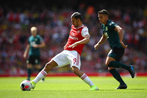 LONDON, ENGLAND - AUGUST 17: Dani Ceballos of Arsenal is closed down by Ashley Westwood of Burnley during the Premier League match between Arsenal FC and Burnley FC at Emirates Stadium on August 17, 2019 in London, United Kingdom. (Photo by Julian Finney/Getty Images)