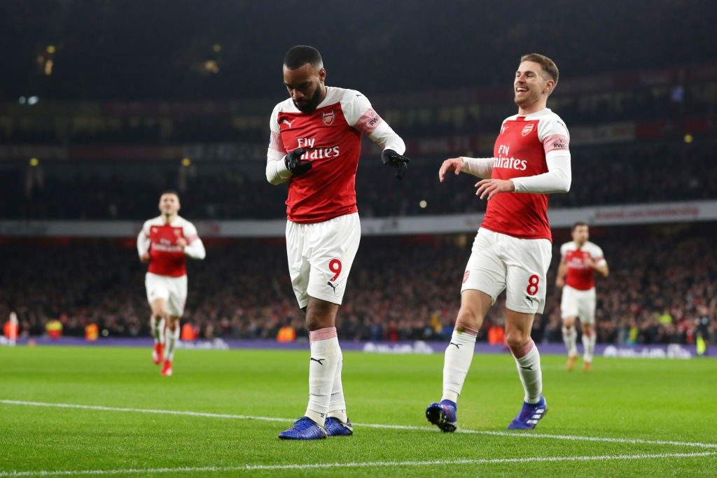 LONDON, ENGLAND - JANUARY 19: Alexandre Lacazette of Arsenal celebrates with teammate Aaron Ramsey after scoring his sides first goal during the Premier League match between Arsenal FC and Chelsea FC at Emirates Stadium on January 19, 2019, in London, United Kingdom. (Photo by Catherine Ivill/Getty Images)